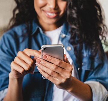 Smiling teen looking at phone