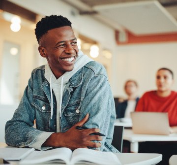 Teenage boy smiling in classroom