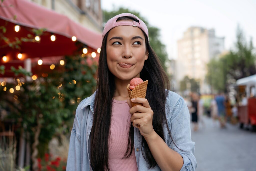 Teenager enjoying ice cream while walking outside